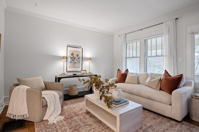 living area featuring ornamental molding, wood finished floors, and visible vents