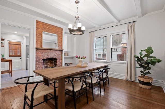 dining area featuring baseboards, wood finished floors, beam ceiling, a fireplace, and a notable chandelier