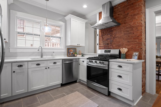 kitchen with a sink, light countertops, appliances with stainless steel finishes, wall chimney exhaust hood, and crown molding