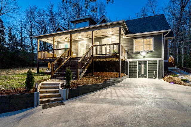 view of front of property with stairway and a shingled roof