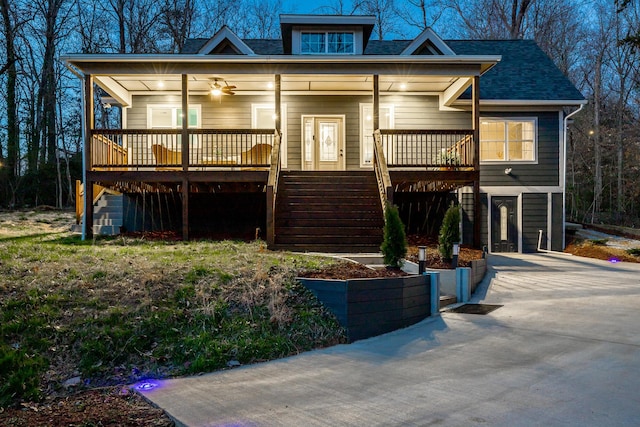 view of front of house featuring stairway, roof with shingles, driveway, a porch, and ceiling fan