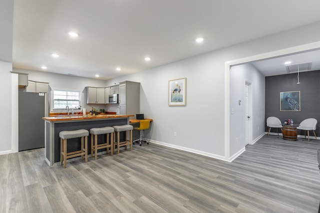4513 Lamont Ln, Chattanooga, TN 37415 - kitchen featuring light wood-style flooring, gray cabinetry, wooden counters, and stainless steel appliances