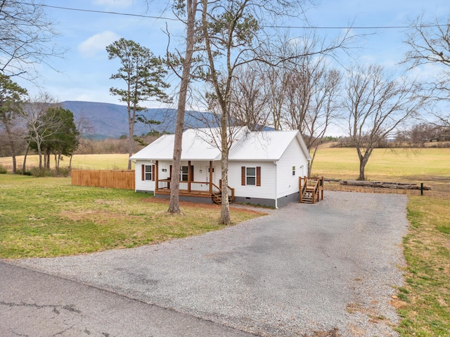 view of front facade with crawl space, covered porch, a front lawn, and gravel driveway