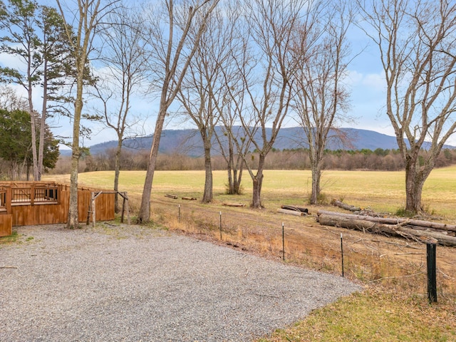 view of yard with a mountain view and fence