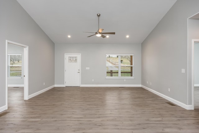 unfurnished living room featuring recessed lighting, wood finished floors, visible vents, and a healthy amount of sunlight