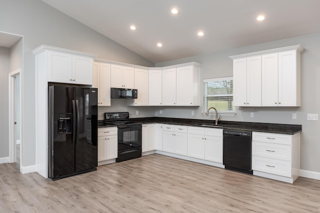 kitchen with white cabinetry, a sink, light wood finished floors, and black appliances