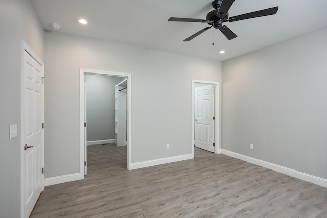 unfurnished bedroom with baseboards, wood finished floors, a ceiling fan, and recessed lighting