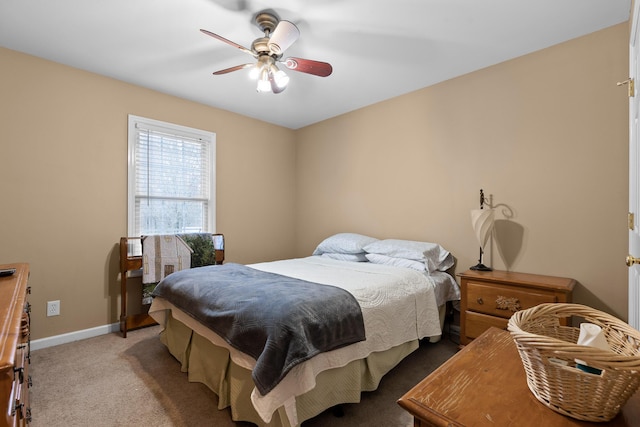 bedroom with ceiling fan, carpet flooring, and baseboards