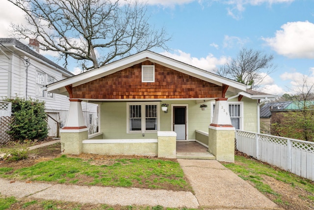 bungalow-style house featuring fence and a porch