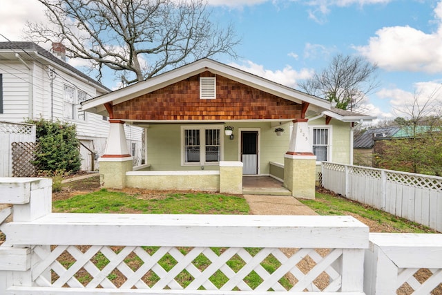 view of front of property with a porch and a fenced front yard