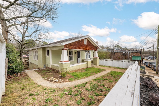 view of front of property featuring covered porch and fence