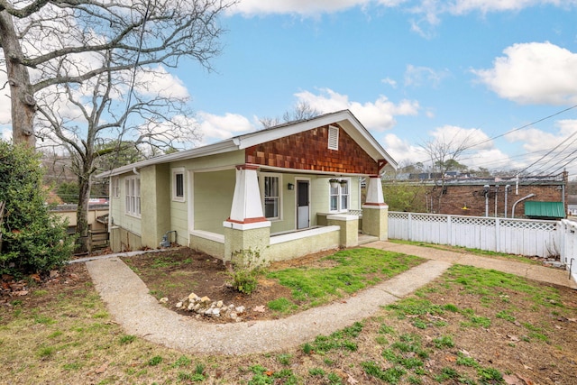 view of front of property featuring a porch and fence