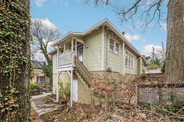 exterior space featuring covered porch and stairs