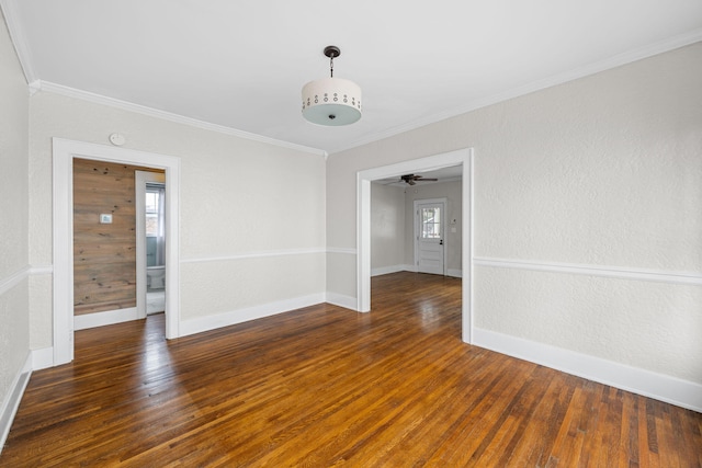 unfurnished room with baseboards, ornamental molding, hardwood / wood-style floors, and a textured wall