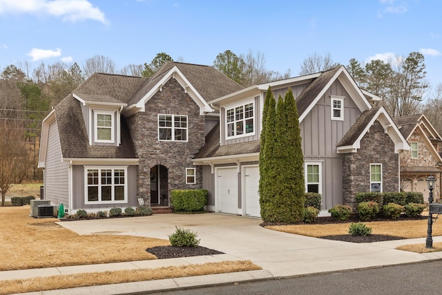 craftsman house with a garage, concrete driveway, stone siding, central air condition unit, and board and batten siding