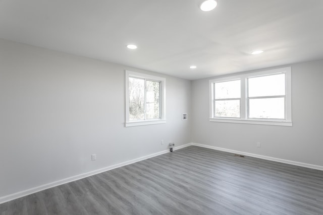 unfurnished room with dark wood-style floors, recessed lighting, and baseboards