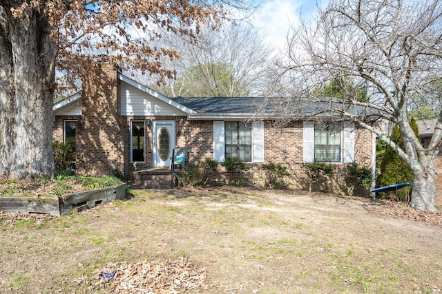 single story home featuring brick siding