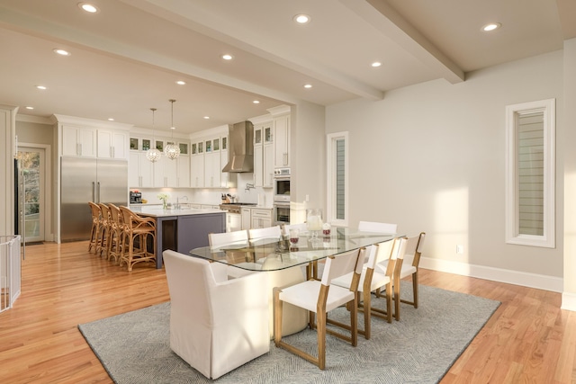 dining space with baseboards, an inviting chandelier, light wood-style flooring, recessed lighting, and beamed ceiling