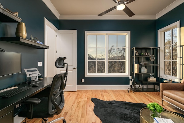 home office with ceiling fan, baseboards, light wood-style floors, and ornamental molding