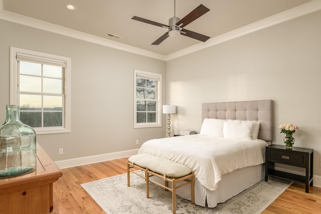 bedroom featuring visible vents, baseboards, light wood-type flooring, ornamental molding, and recessed lighting