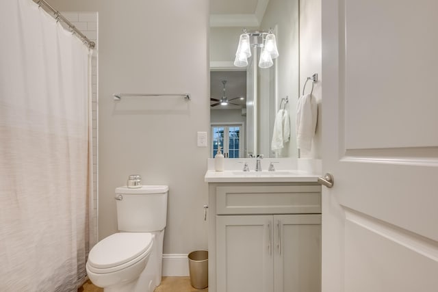 bathroom featuring baseboards, toilet, a shower with shower curtain, vanity, and a ceiling fan