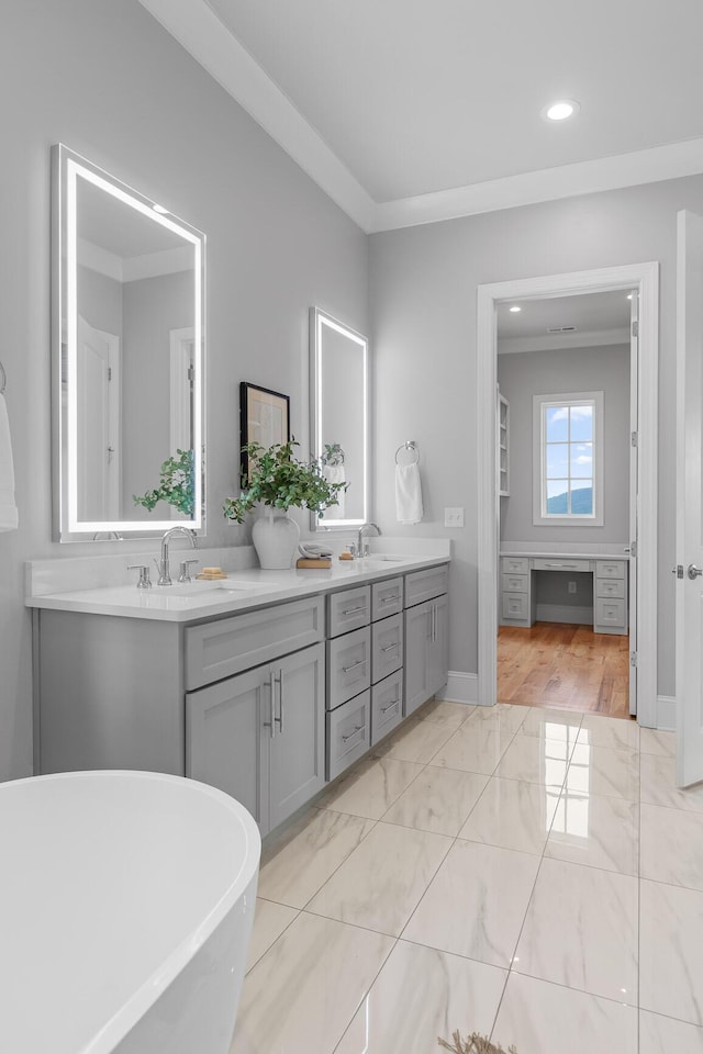 1109 Meroney St, Chattanooga, TN 37405 - bathroom with double vanity, marble look tiles, a freestanding bath, recessed lighting, and ornamental molding