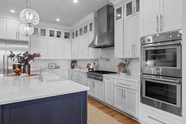 1109 Meroney St, Chattanooga, TN 37405 - kitchen with appliances with stainless steel finishes, wall chimney exhaust hood, light countertops, recessed lighting, and white cabinets