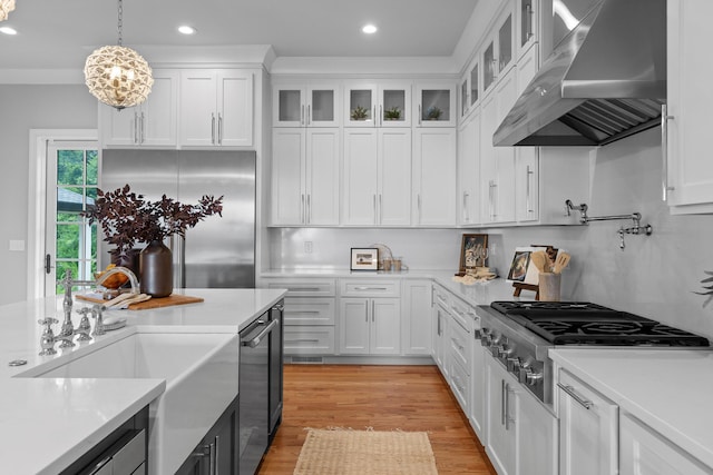 1109 Meroney St, Chattanooga, TN 37405 - kitchen featuring wall chimney exhaust hood, stainless steel appliances, recessed lighting, white cabinets, and light countertops