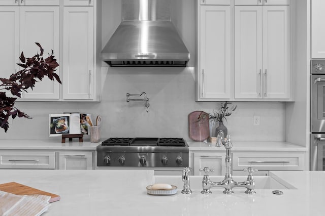 1109 Meroney St, Chattanooga, TN 37405 - kitchen with wall chimney exhaust hood, light countertops, and white cabinetry