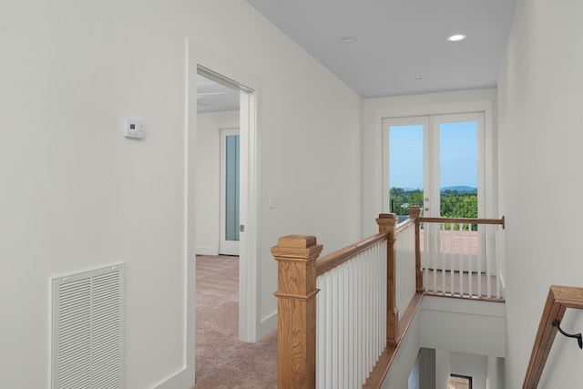 corridor featuring baseboards, visible vents, an upstairs landing, carpet floors, and recessed lighting