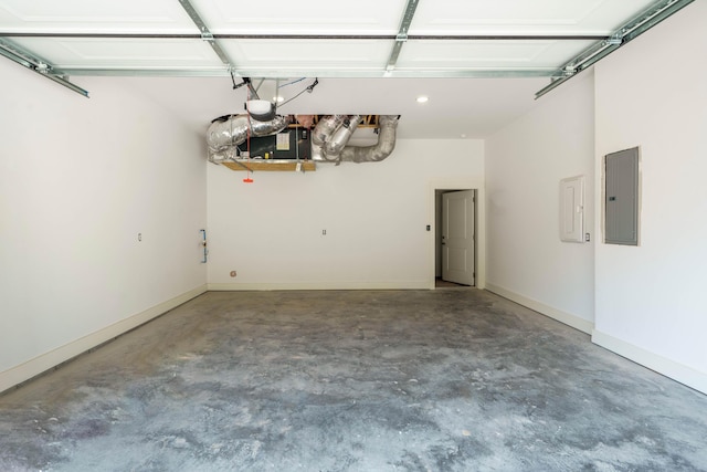 garage with a garage door opener, electric panel, and baseboards