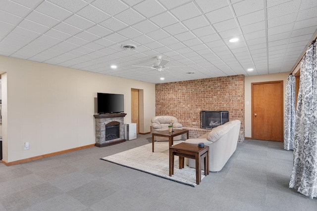 carpeted living area featuring recessed lighting, a fireplace, visible vents, and baseboards