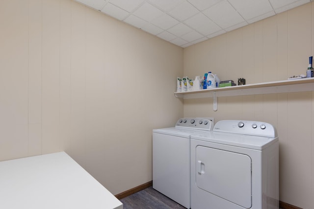 washroom with laundry area, washing machine and clothes dryer, and dark wood finished floors