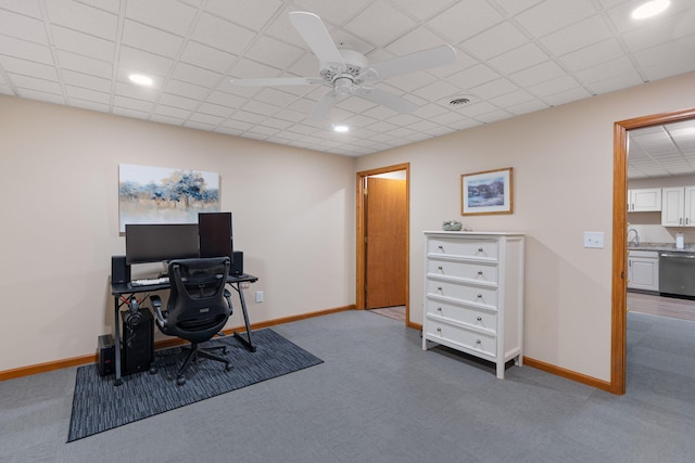 carpeted home office with a paneled ceiling, visible vents, and baseboards