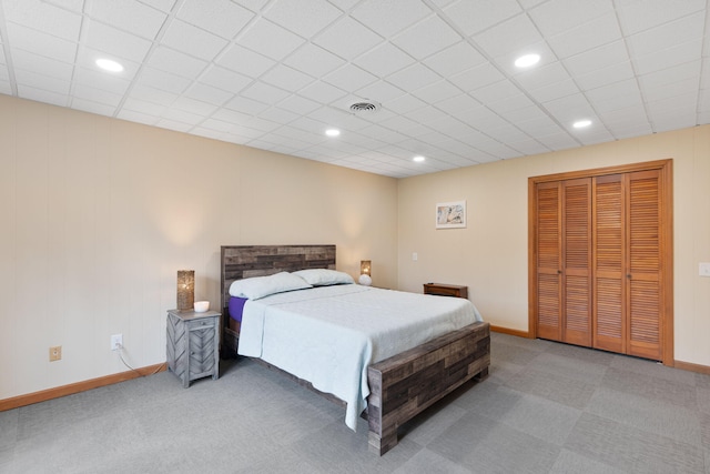 bedroom with carpet floors, a closet, visible vents, and baseboards