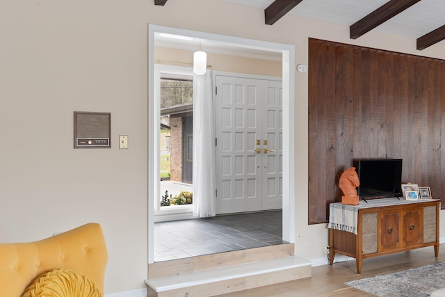 entrance foyer featuring wood ceiling, beamed ceiling, and wood finished floors