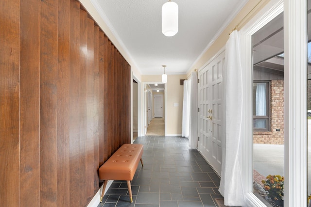 hall featuring a textured ceiling and crown molding