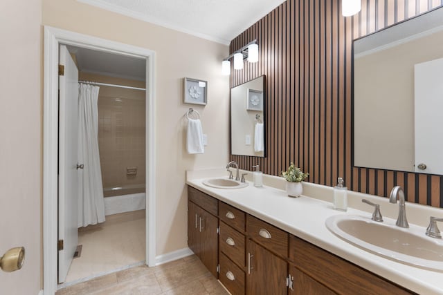 bathroom with double vanity, ornamental molding, a sink, and tile patterned floors