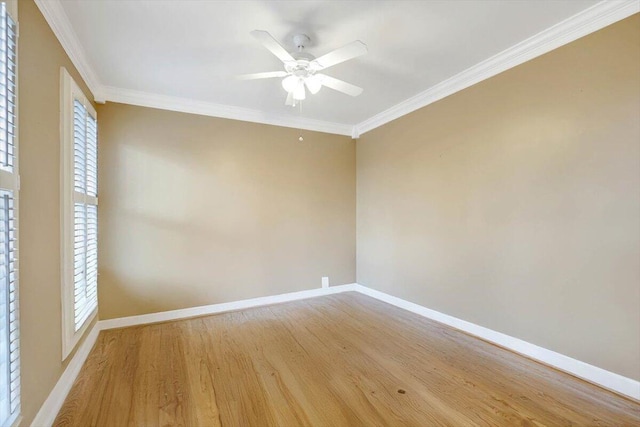 spare room with crown molding, light wood-style flooring, and baseboards