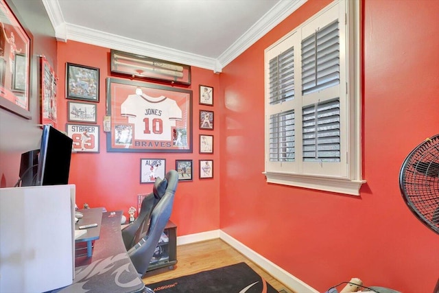 office space with baseboards, crown molding, and wood finished floors