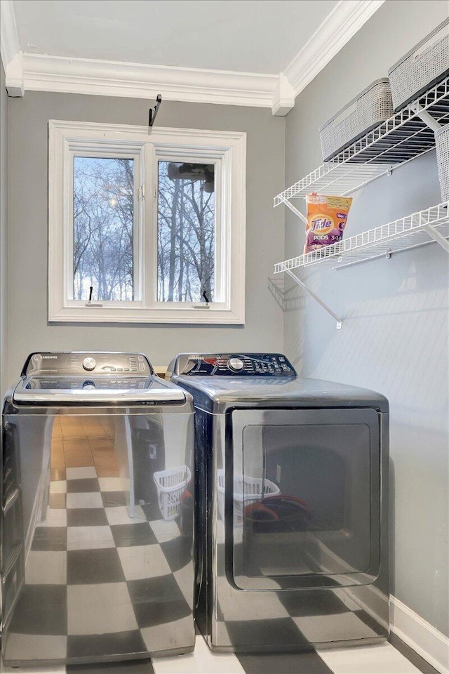 laundry room featuring laundry area, plenty of natural light, ornamental molding, and washer and clothes dryer