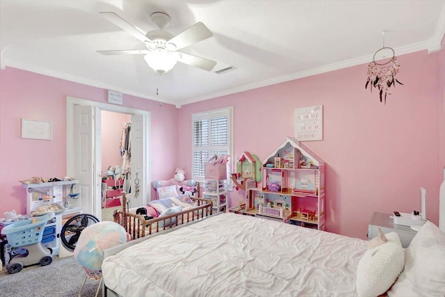 carpeted bedroom with visible vents, a ceiling fan, and crown molding