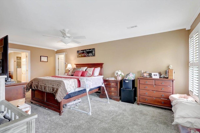 carpeted bedroom with ceiling fan, visible vents, and crown molding