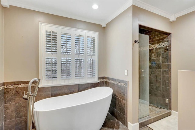 bathroom featuring a stall shower, crown molding, a freestanding tub, tile walls, and recessed lighting