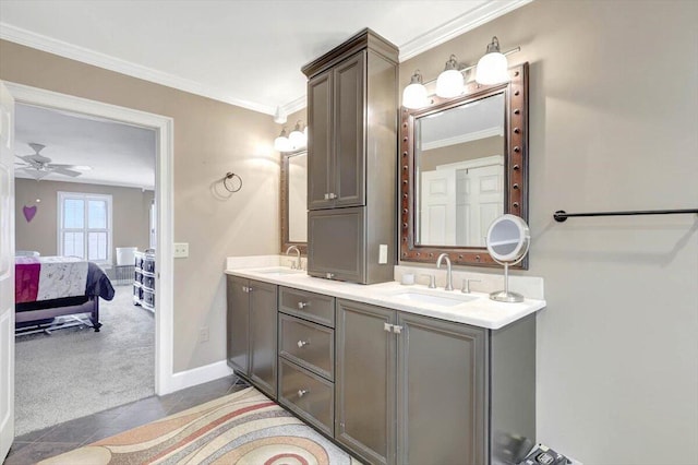 full bath featuring double vanity, connected bathroom, ornamental molding, and a sink