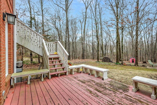 wooden deck with stairs and a wooded view