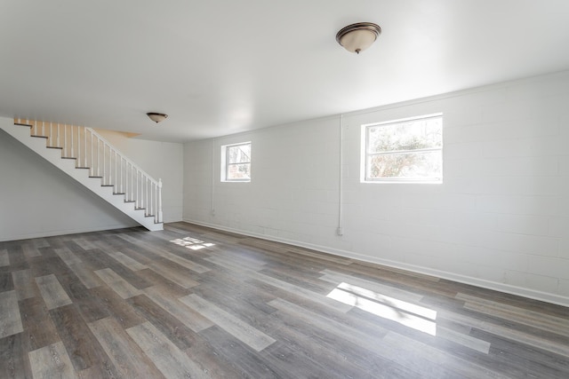 basement featuring stairs, wood finished floors, and baseboards