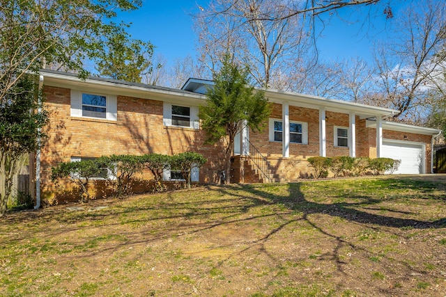 view of front of house with brick siding, a front yard, and an attached garage