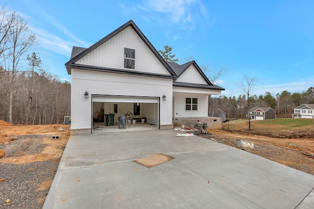 modern farmhouse style home with driveway and roof with shingles