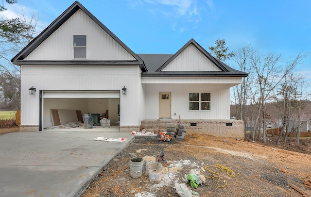 modern inspired farmhouse with a shingled roof, crawl space, driveway, and a garage